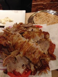 Gyro Greek style -- served almost like nachos with the meet on top of the sliced onions, tomatoes, sauce, and pita bread