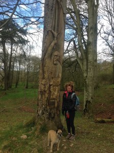 Beth and Bruce on a hike around Loch Castle near a tree with a carving of Robert the Bruce